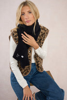 Close view of Molly Bracken black scarf with ribbed trim and stitched detail