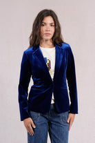 Molly Bracken navy velvet blazer styled casually with denim Jeans