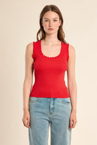 	Molly Bracken red fitted ribbed tank top styled with denim jeans