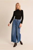Molly Bracken black slim fit high neck top styled with blue jeans