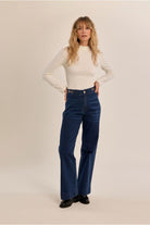 Molly Bracken cream slim fit high neck top styled with blue jeans