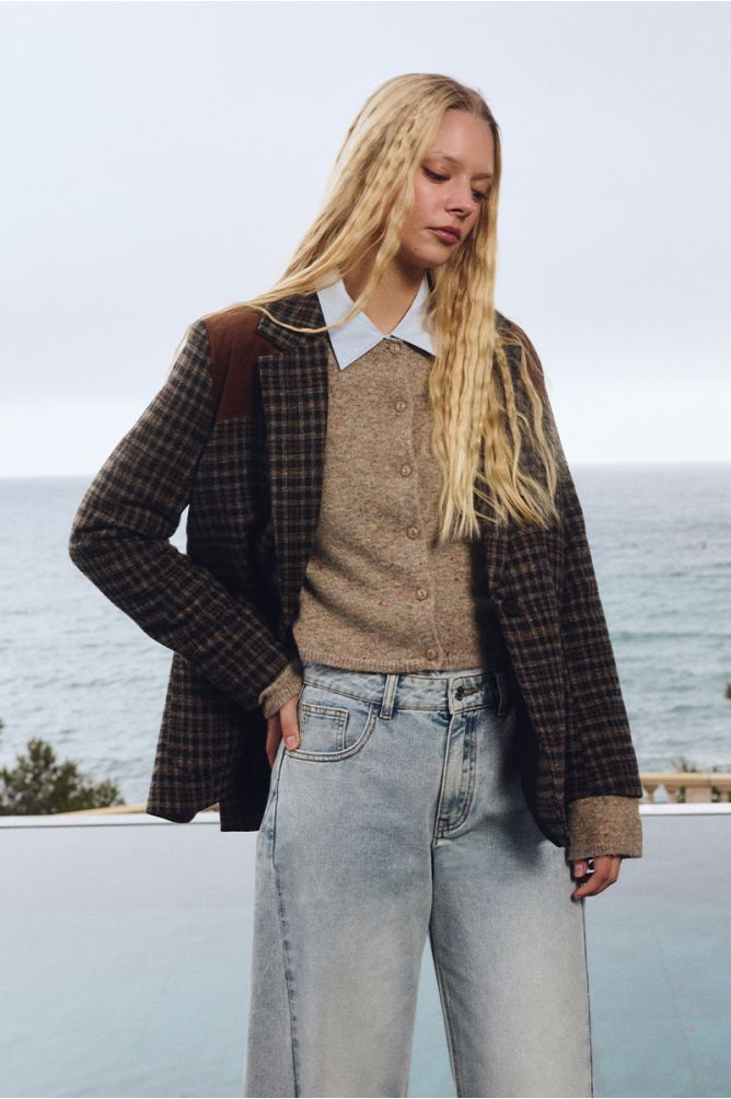 MMolly Bracken beige flecked knit women’s cardigan paired with winter jacket and jeans 