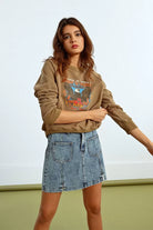 Model wearing Molly Bracken camel brown eagle motif sweatshirt, side pose