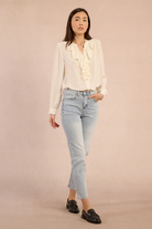 Molly Bracken cream blouse styled with jeans, full outfit view