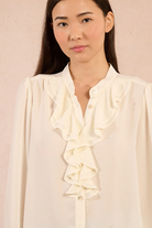 Molly Bracken cream blouse close-up of neckline and ruffles