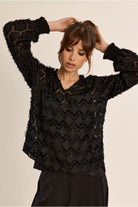 Molly Bracken semi-sheer black V-neck blouse close-up