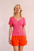 Fitted ribbed top with romantic ruffle sleeves and flattering cut