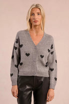Model wearing Molly Bracken grey heart motif knitted cardigan with leather trousers
