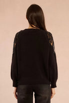 Back view of black lace shoulder knit jumper with scoop neckline