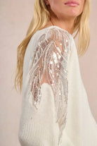 Molly Bracken angle view of cream knit sweater with balloon sleeves and lace shoulders