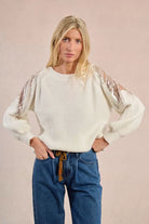 	Front view of cream Molly Bracken knit sweater with lace and rhinestone sleeves