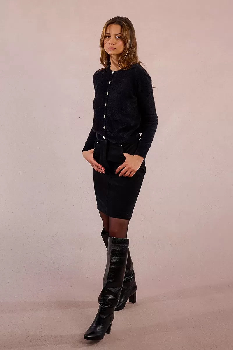 	Soft black knit texture and decorative button detail – Molly Bracken