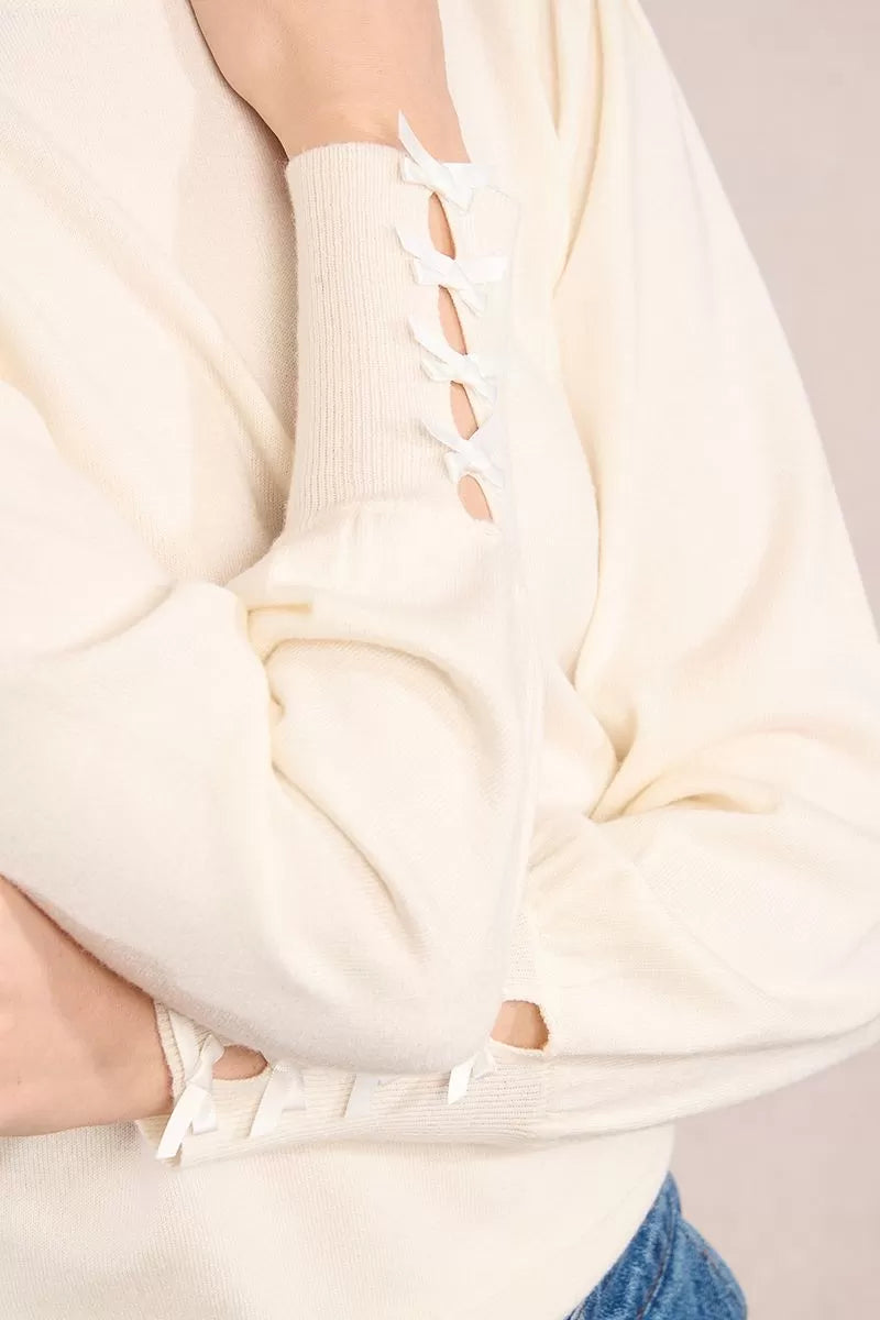 Close-up of sleeve bow detail on Molly Bracken knitted jumper