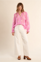 Molly Bracken pink semi sheer blouse styled with cream trousers
