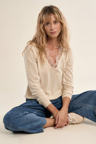 Molly Bracken beige fine knit jumper styled with jeans
