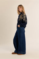 Molly Bracken navy pearl detail jumper styled with blue jeans