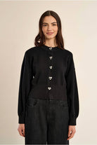 Molly Bracken black knit cardigan styled with wide leg trousers