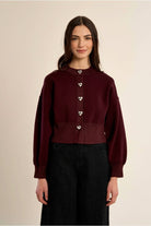Molly Bracken burgundy knit cardigan styled with black trousers