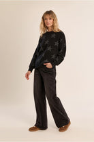 Molly Bracken black iridescent star jumper styled with wide leg trousers