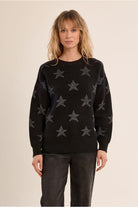     Molly Bracken black iridescent star knit jumper front view on woman