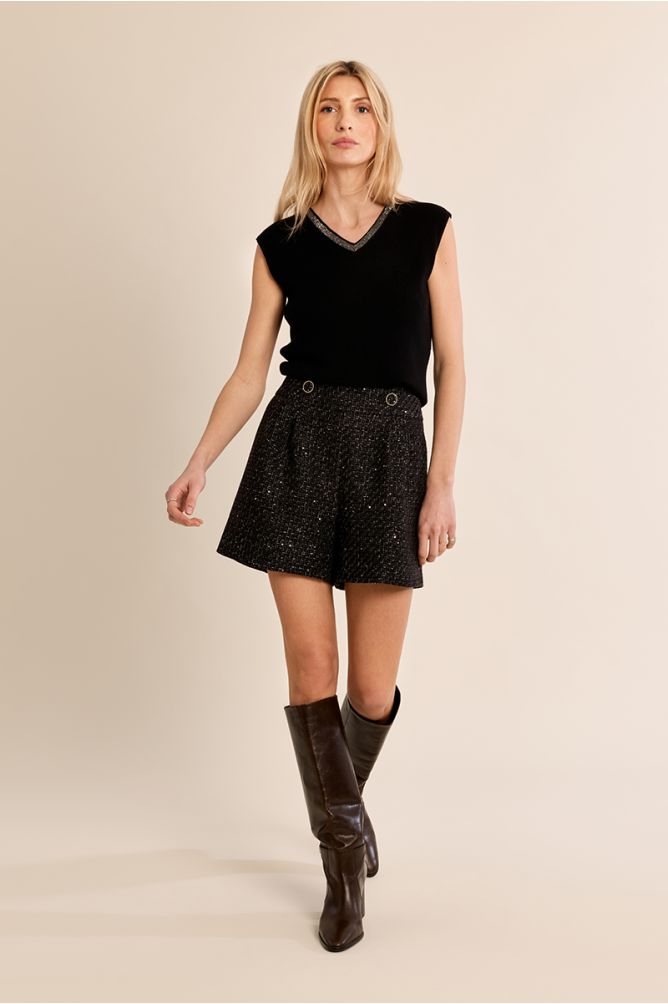Molly Bracken black iridescent V-neck top styled with shorts