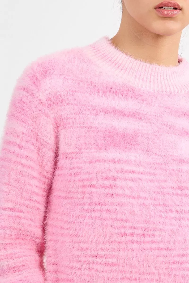Molly Bracken soft pink fluffy knit jumper with dark trousers 
