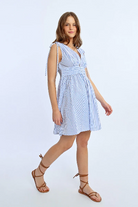 Front view of blue and white striped mini dress with waist button detail