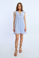 Woman wearing Molly Bracken striped sleeveless dress with V-neck and tie shoulders