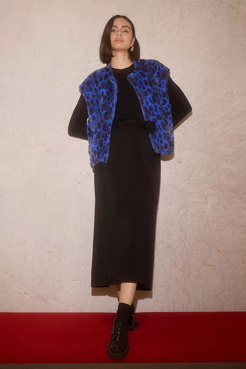 Molly Bracken long black skirt styled with blue faux fur vest
