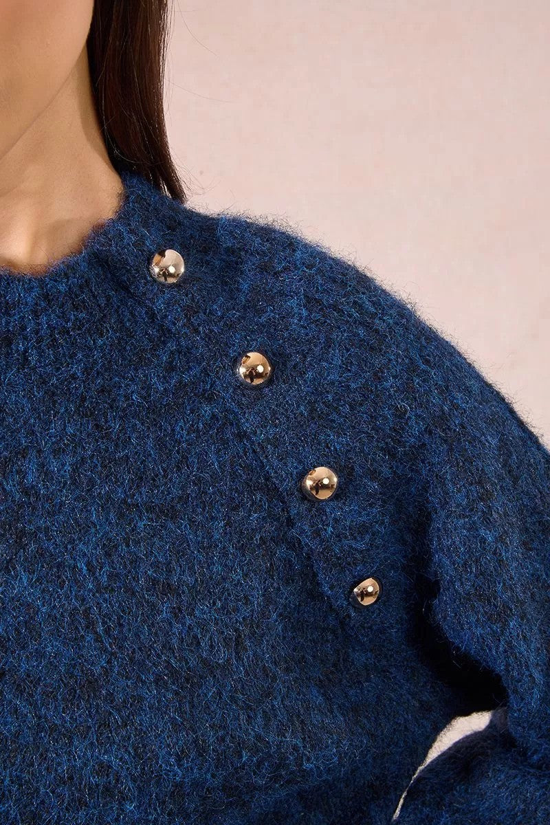 Close-up of metallic gold button detailing on Molly Bracken blue jumper