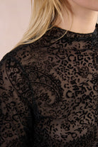 Close-up of Molly Bracken black flocked paisley mesh top neckline and collar detail.