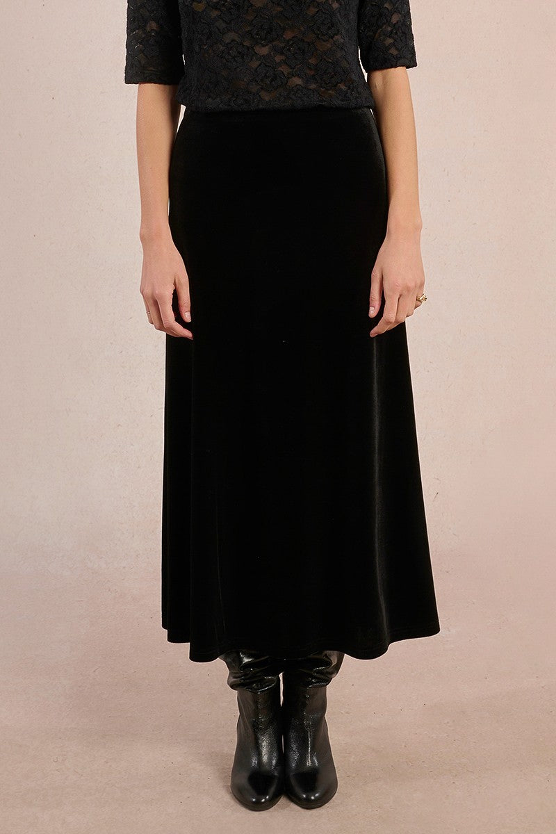 Front view of Molly Bracken long black velvet skirt styled with boots.