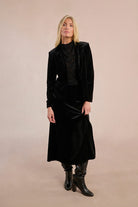 Full front view of Molly Bracken black velvet maxi skirt with side slit.