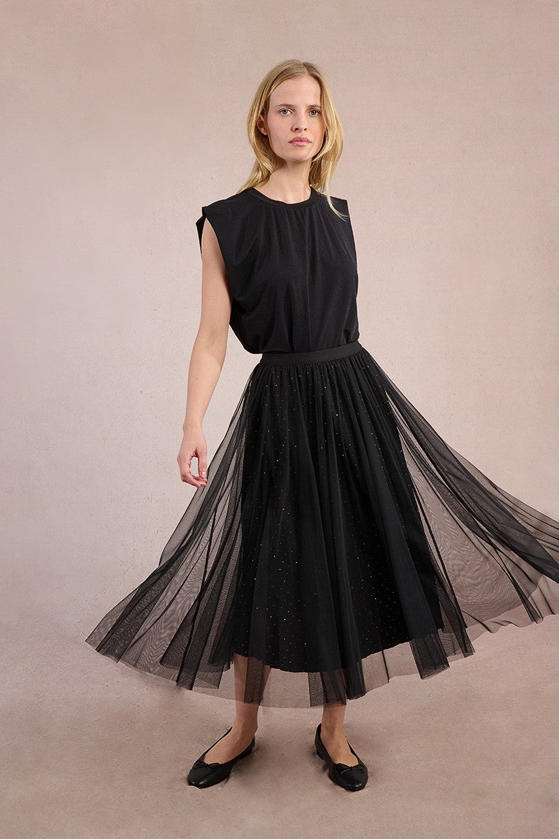 Model wearing Molly Bracken black polka dot maxi skirt with sleeveless top.