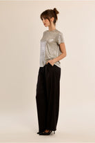 Molly Bracken beige shimmer T-shirt styled with black trousers