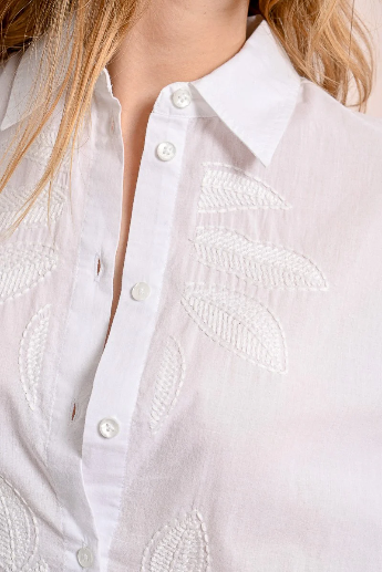 White button-up shirt with subtle embroidered texture closeup