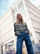Close-up of Mos Mosh Dara Hera jeans showing high-rise fit and wide-leg silhouette.
