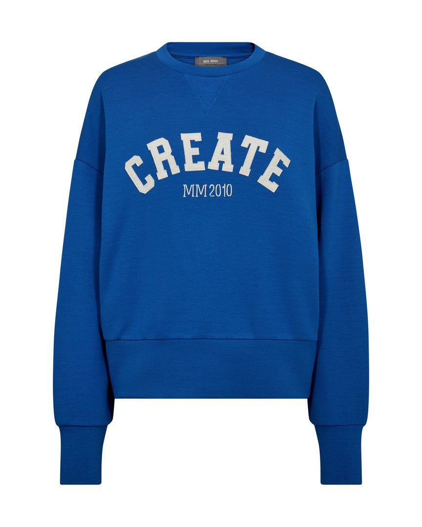 Model wearing Mos Mosh Celi Create cobalt-blue sweatshirt with slogan