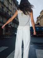 Back view of Mos Mosh white high-waisted lyocell trousers styled with striped summer top