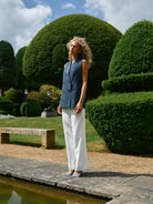 Model wearing Mos Mosh white wide-leg trousers