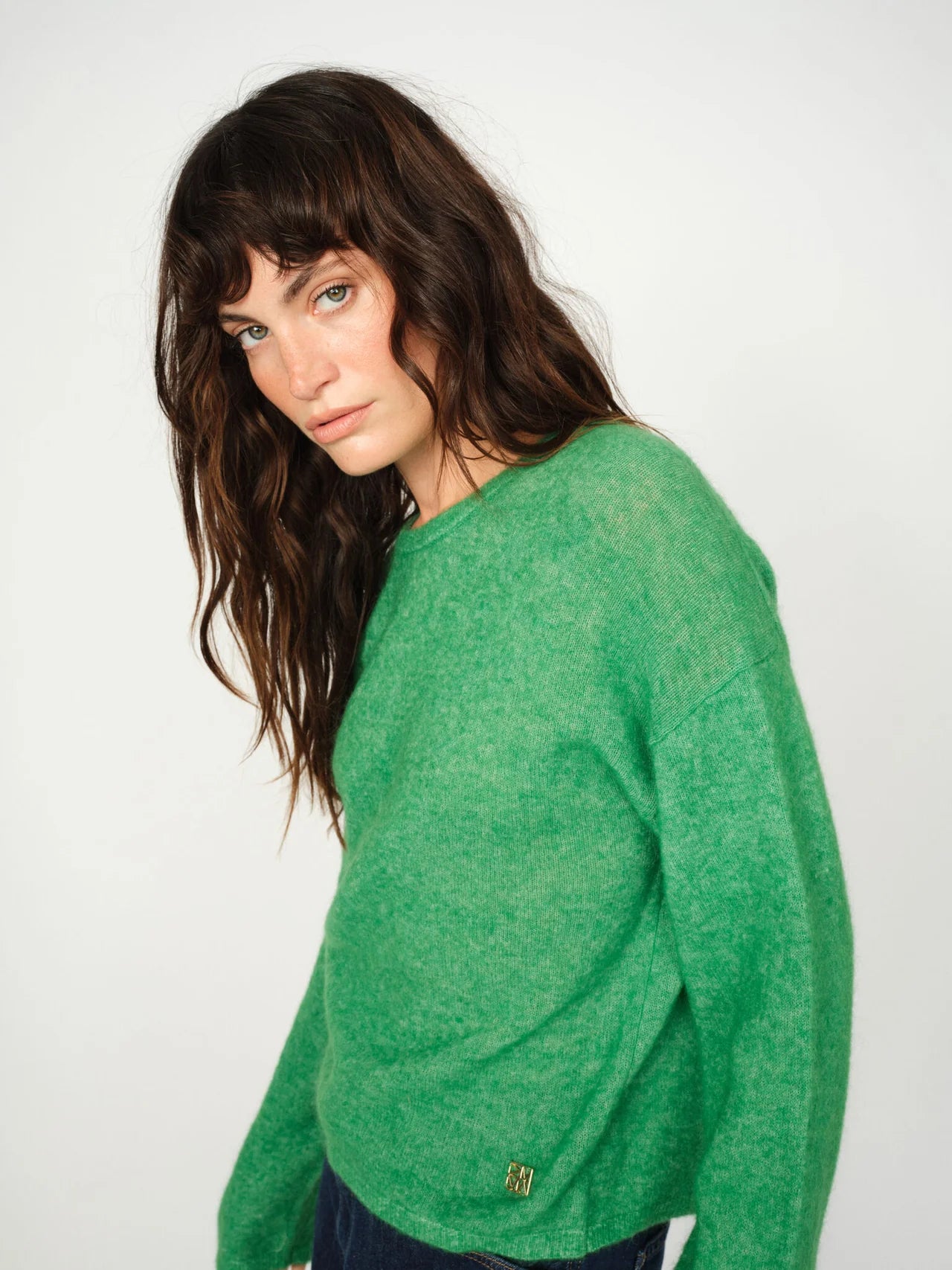Model wearing Mos Mosh Mape O-neck green wool jumper with relaxed pose