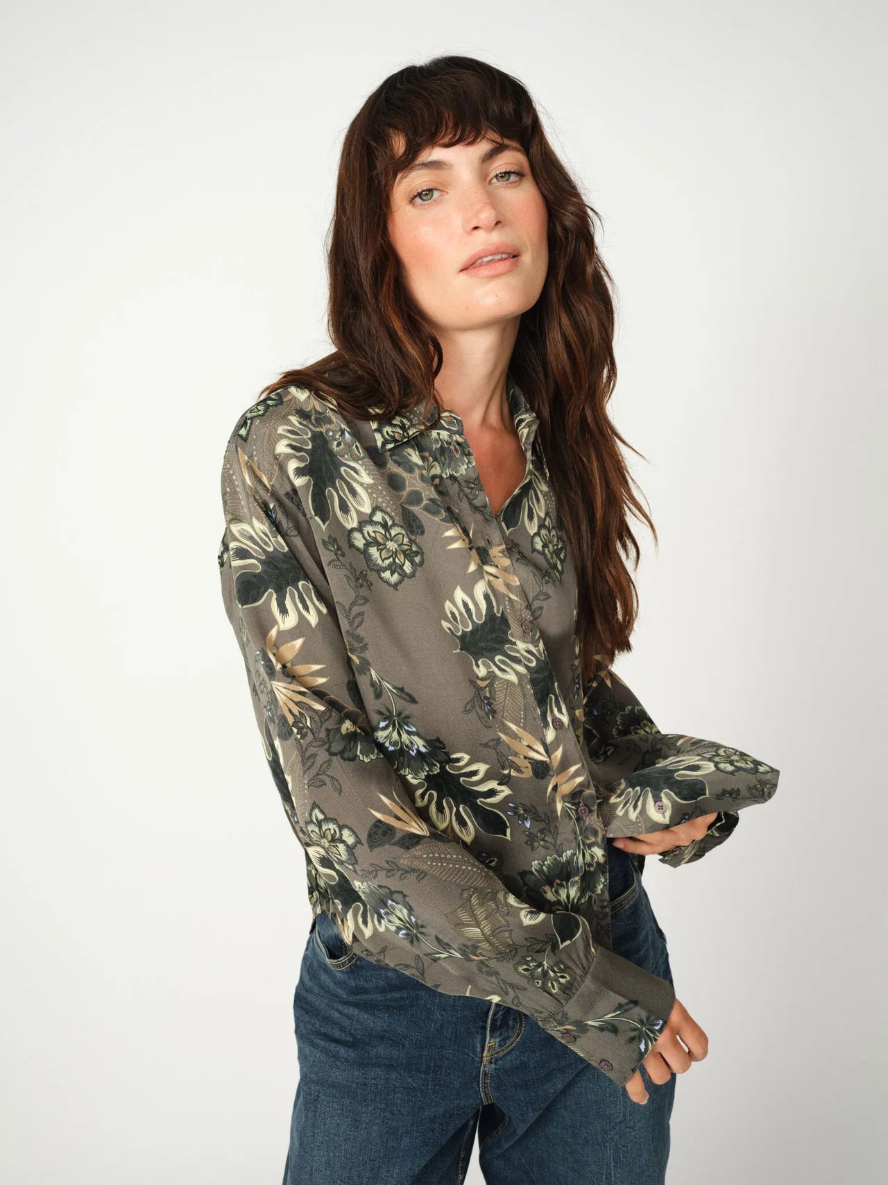 Close-up of floral print and buttoned cuffs on green Mos Mosh shirt
