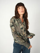 Close-up of floral print and buttoned cuffs on green Mos Mosh shirt