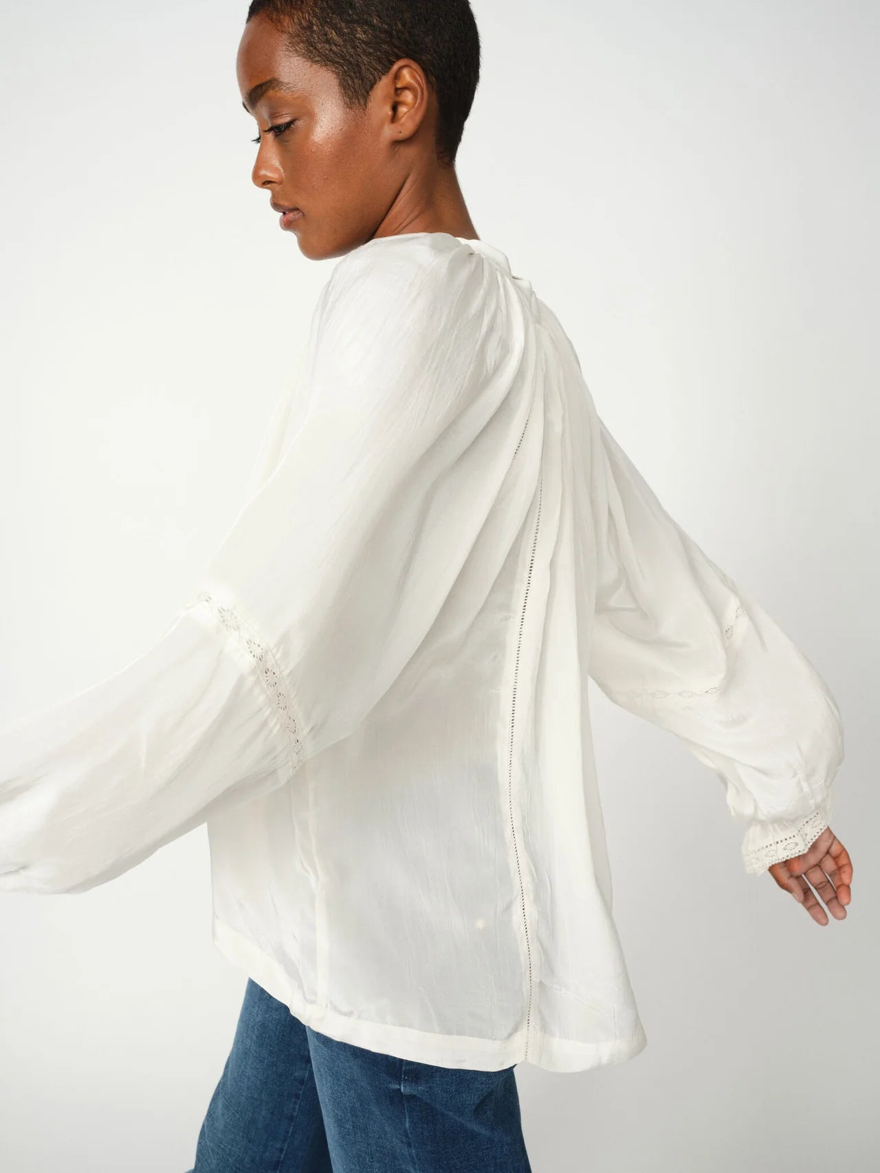 Side view of Mos Mosh Vuela loose-fit white blouse with long sleeves