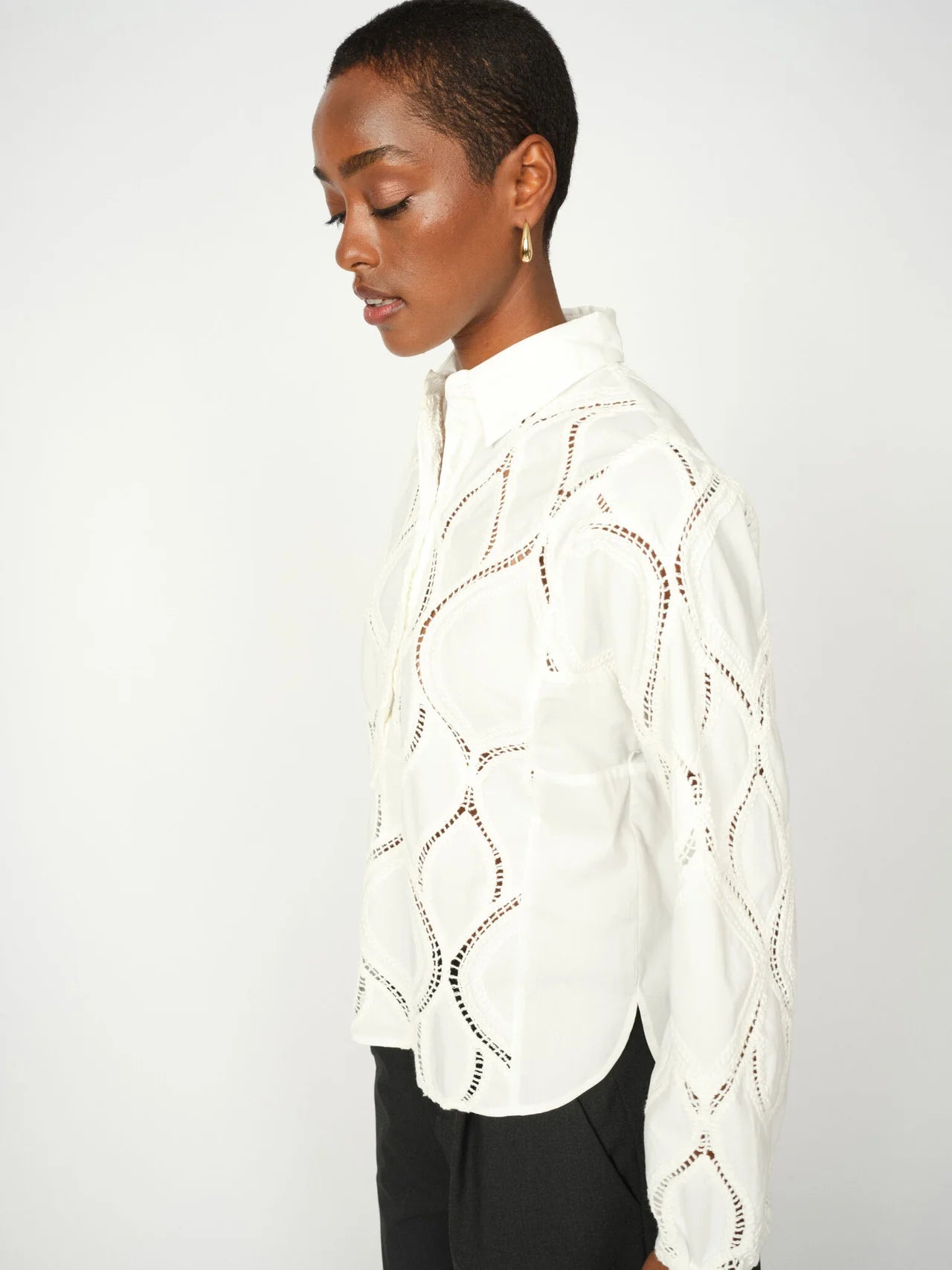 Close-up of graphic openwork detail on Mos Mosh cream blouse