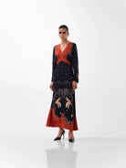 NOIB Aura Old Rose black maxi dress with orange-red botanical print and beaded V-neck – front model view.