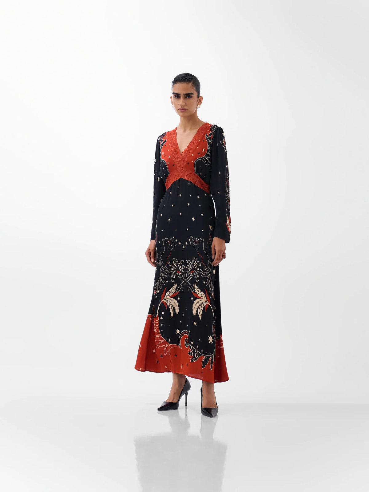 NOIB Aura Old Rose black maxi dress with orange-red botanical print and beaded V-neck – front model view.
