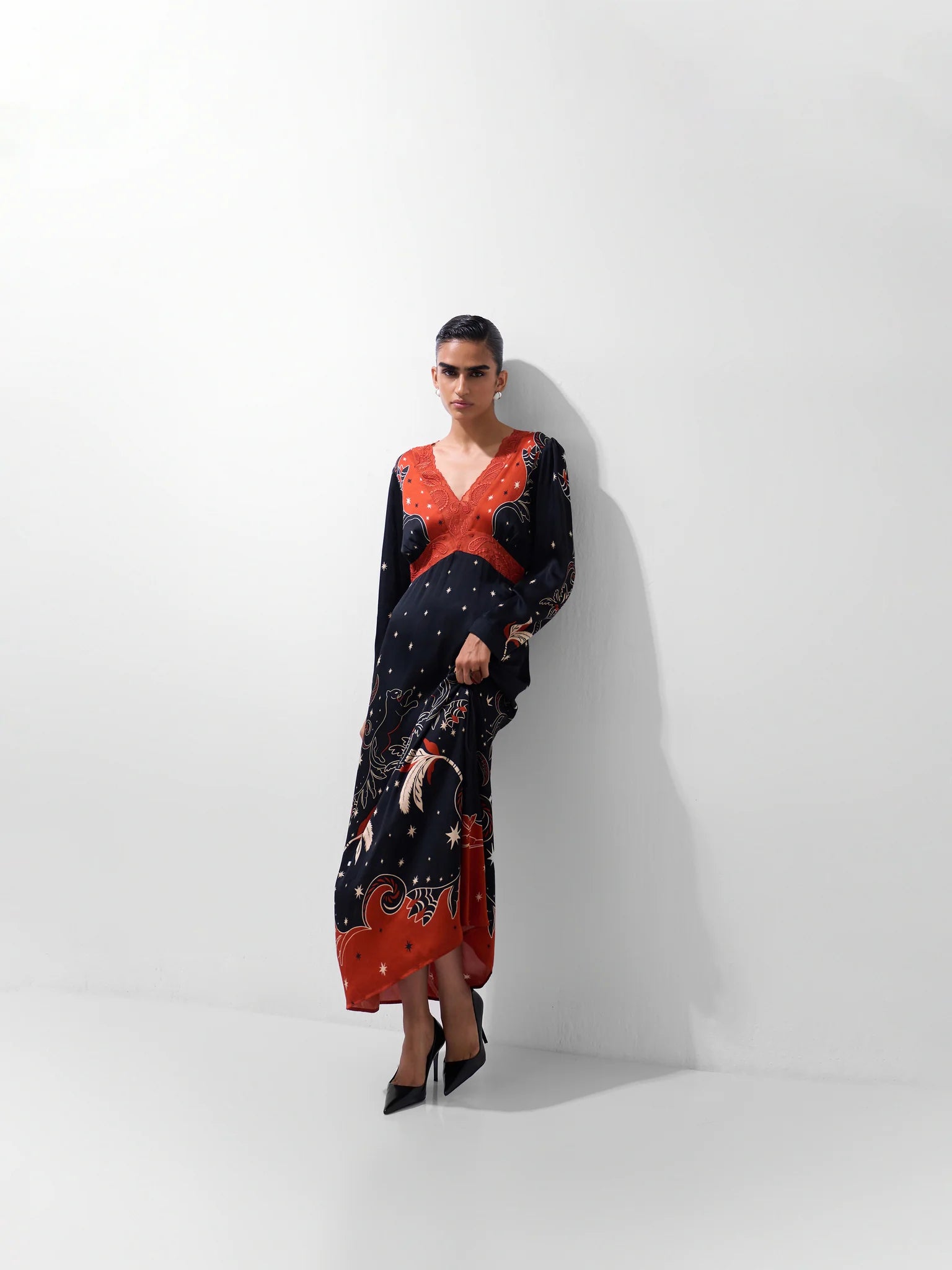 NOIB Aura Old Rose botanical print maxi dress styled with black pointed heels – full model view.