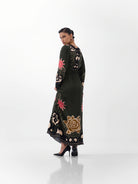 NOIB Aura Nocturnal Jungle printed maxi dress showing botanical motifs across the sleeves and back – rear view.