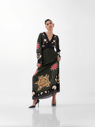 NOIB Aura Nocturnal Jungle green printed maxi dress with long sleeves and decorative border print – angled front view.